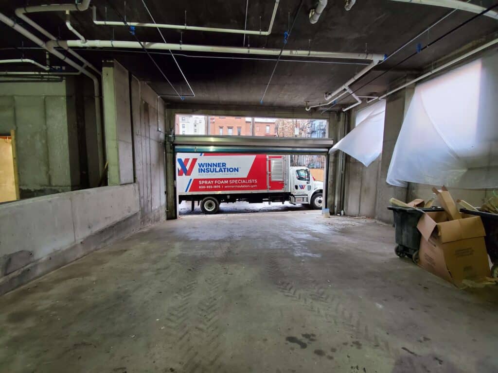 commercial building with winner insulation truck parked in the garage