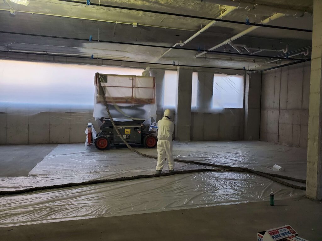 winner insulation professionals installing spray foam insulation in a commercial building