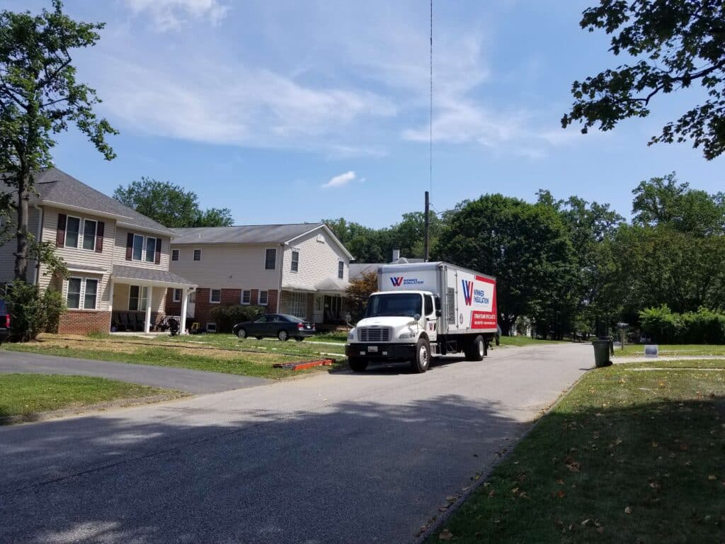 residential neighborhood with Winner Insulation truck parked on the street