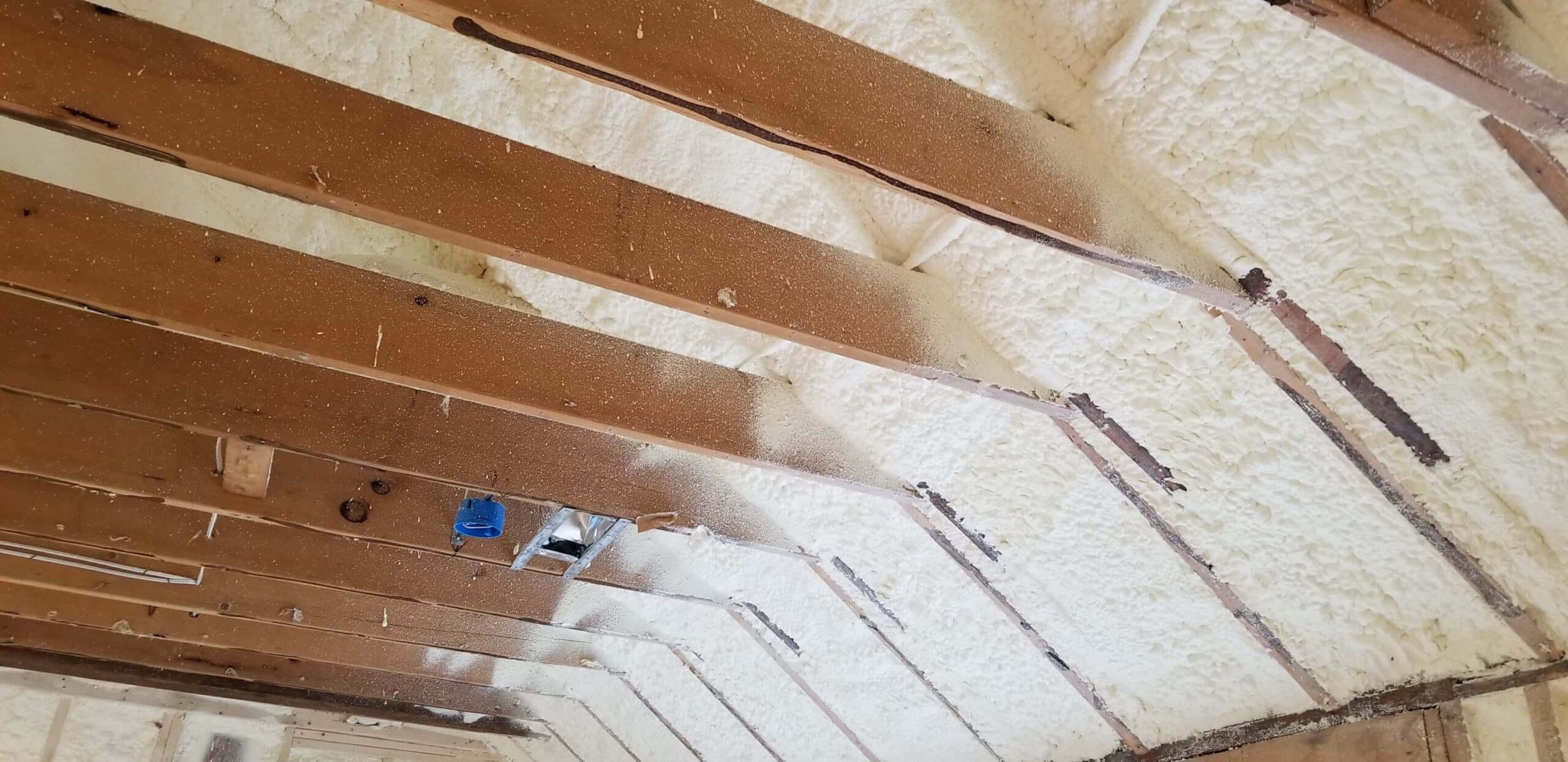 Spray foam insulation applied in an attic.